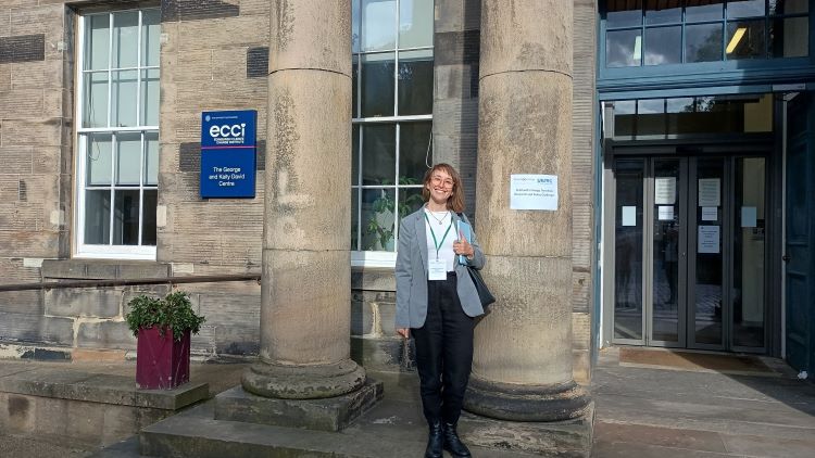 Student standing outside the Edinburgh Climate Change Institute